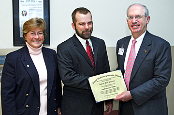 Medical student Andrew Sitzmann, center, received the Raoul Wallenberg Scholar Award from Dr. Jeffrey Gold, provost and executive vice president for health affairs and dean of the College of Medicine, and Dr. Patricia Metting, College of Medicine associate dean for student affairs and vice provost for student affairs on the Health Science Campus.