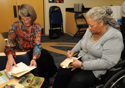 Barbara Floyd, director of the Ward M. Canaday Center for Special Collections, opened rare editions for Toni Morrison to sign prior to the lecture. The books are housed in the center in Carlson Library.