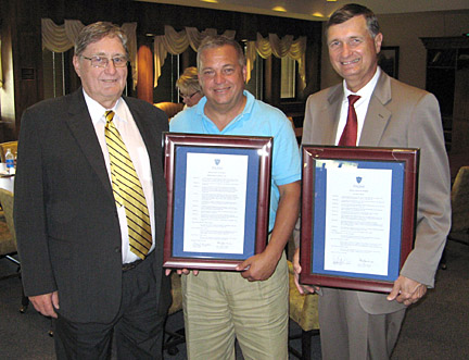 President Lloyd Jacobs presented resolutions to outgoing Board Chair Richard Stansley, center, and David Huey, who both completed their terms as trustees.