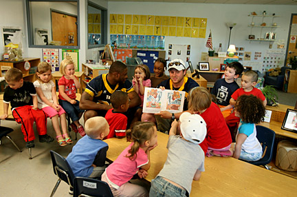 Toledo quarterback Aaron Opelt read to students at Apple Tree Nursery School while running back DaJuane Collins waited for his turn. The summer visit by the UT seniors is featured in September’s UT Matters segment. 