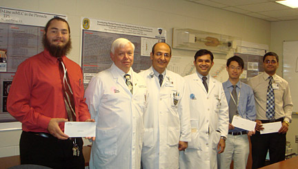 From left, PhD candidate Nicholas Sperling; Toledo Radiation Oncology Physician Group members Dr. John Feldmeier, professor and chair of  radiation oncology; Dr. Ishmael Parsai, professor and director of the graduate medical physics program and chief of medical physics; and Dr. Faheem Ahmad; and PhD candidates Xiance Jin and Bhoj Gautam