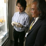 Dr. Hironori Matsushima, left, and Dr. Akira Takashima look at a culture dish to see if the antimicrobial proteins can kill bacteria. The researchers plan to incorporate those proteins into a powdered milk that would help solve the problem of chronic diarrhea in children of developing countries.