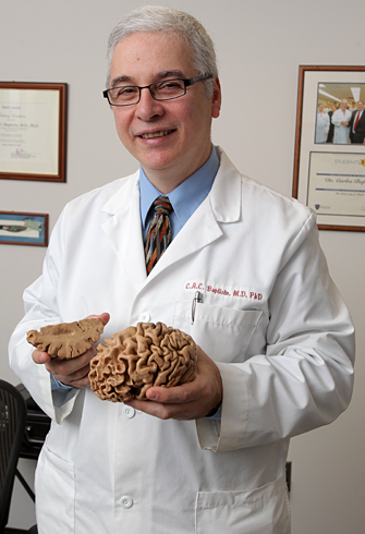 Dr. Carlos Baptista holds a plastinated brain.