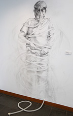 “Communication Barriers,” wall drawing with charcoal and found object, by Michele Sanderson