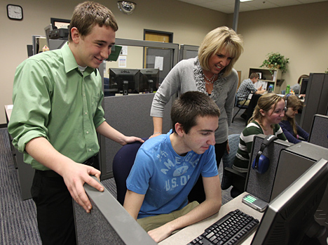 Angela Paprocki talked with Chris Brown, seated, and Nick Ruth who work in the Office of Accessibility.