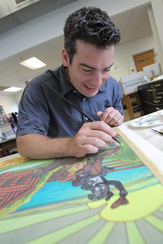 Arturo Rodriguez worked on a poster in the Center for the Visual Arts.