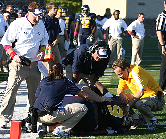 In this 2011 photo, Dr. Roger Kruse, right, tended to an injured player.