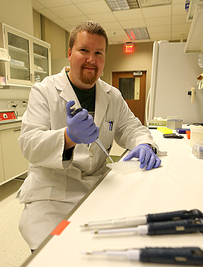 Dr. Lance Stechschulte sets up a real-time polymerase chain reaction plate to detect the expression of target genes.