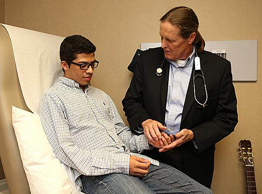 Dr. Jeffrey Hammersley asked Benjie Benitez how his hands were doing during a visit to UT Medical Center earlier this month. The Honduran teen was diagnosed with a rare mitochondrial disease that leads to muscle breakdown.