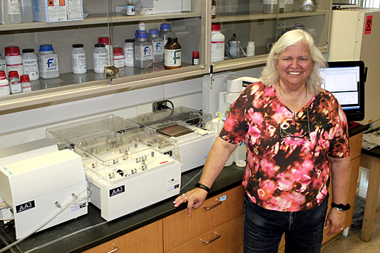Brenda Snyder posed for a photo in her lab at the UT Lake Erie Center next to the SEAL AutoAnalyzer, a new lab instrument that she is working to get up and running by mid-July. Instead of sending samples to another lab to be analyzed for levels of nutrients, she will be able to do it at the Lake Erie Center – which means results will be available sooner.