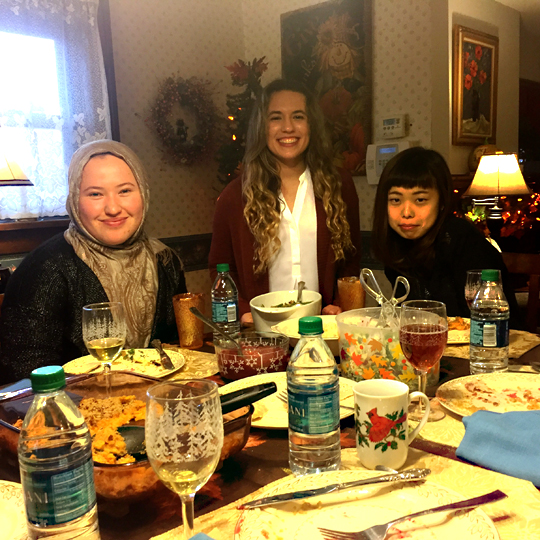 UT student Maggie Nigro, center, invited Arofat Rakhmankulova of Uzbekistan, left,  and Mayu Adachi of Japan for Thanksgiving dinner. 