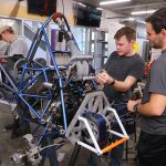 From left, senior Tyler Zeller, sophomore William Ezakovich, sophomore Tim Del Signore and senior Ian King, all of whom are mechanical engineering students, work on the Rocket Motorsports team racecar.
