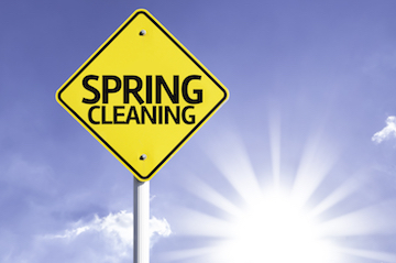 Spring Cleaning road sign with sun background