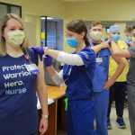 UTMC healthcare wokers stand in a line recieve COVID-19 vaccine