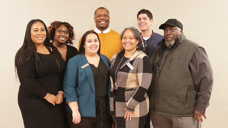 From left to right, Tessa Scott, Office of Multicultural Student Success program manager; Kyndra Gaines, program manager in the OMSS; Aleiah Jones, associate director of OMSS; Willis; Young. In back, Robert Woodley, OMSS program manager for retention, and Ramirez.