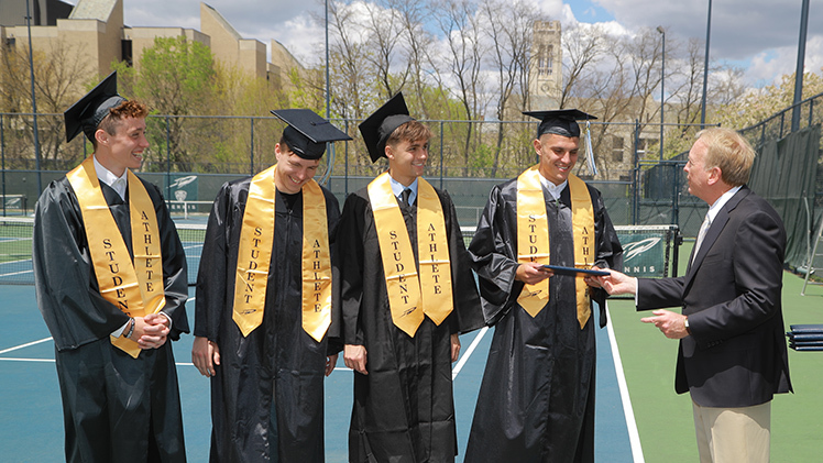 UToledo President Gregory Postel presented diplomas to five senior class members of the Toledo men's tennis team who will be competing in the NCAA tournament at the same time as commencement ceremonies. Postel recognized, from left, Krzysztof Wetoszka, Luka Jankovic, Max Skaer and Luis Kleinschnitz.