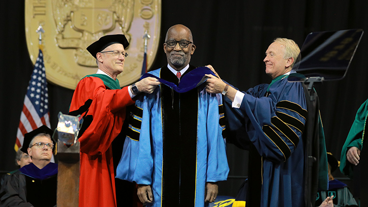 Dr. Christopher Cooper, dean of the College of Medicine and Life Sciences, and UToledo President Gregory Postel award an honorary doctor of science degree to Dr. David R. Williams, an internationally recognized social scientist whose research has illustrated the negative effects that racial discrimination has on health.