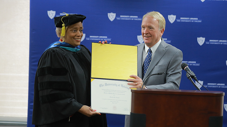 UToledo President Gregory Postel presents Dr. Suzette R. Cowell an honorary doctor of public service degree from The University of Toledo during a Tuesday breakfast reception at the Carlson Library Main Event Space.