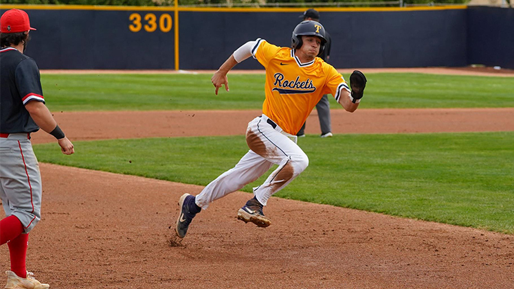 Photo of Toledo junior infielder Jeron Williams running to home base during a baseball game.