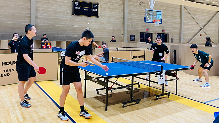 Photo of players playing table tennis at the first UToledo Table Tennis Invitational hosted in April by the UToledo student organization Juice House along with the UToledo Table Tennis Club and Student Recreation Center.
