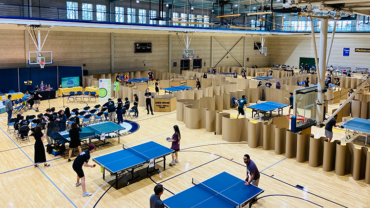 Photo of players playing table tennis at the first UToledo Table Tennis Invitational hosted in April by the UToledo student organization Juice House along with the UToledo Table Tennis Club and Student Recreation Center.