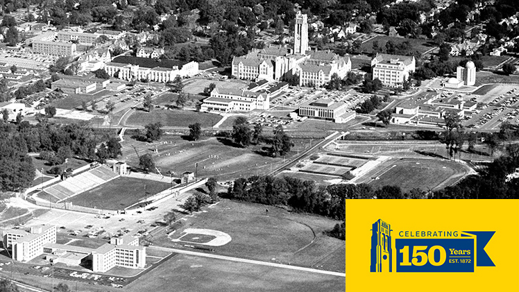 A black-and-white aerial photo of the UToledo campus in 1967 with the UToledo Sesquicentennial logo at the bottom right corner.