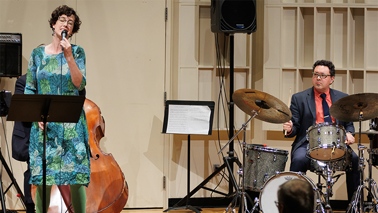 A photo of a performance by jazz vocalist Ellie Martin, an adjunct instructor in the Department of Music, and her husband, Dr. Olman Piedra, an associate professor of percussion and drum set at UToledo.