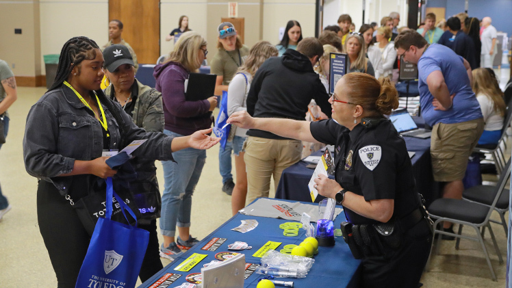 UToledo Police Officer Jeni Gerber interacts with a student during a morning information fair in Thompson Student Auditorium as part of a recent Rocket Launch event.