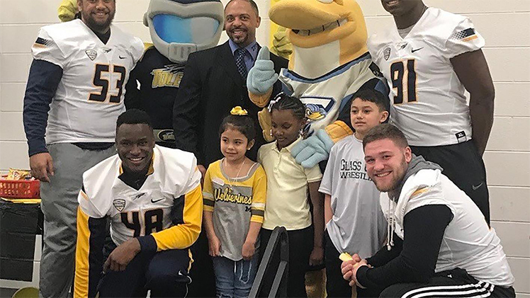A group photo of children and University of Toledo linebacker Daniel Bolden, far right, who was nominated for the 2023 Allstate AFCA Good Works Team.