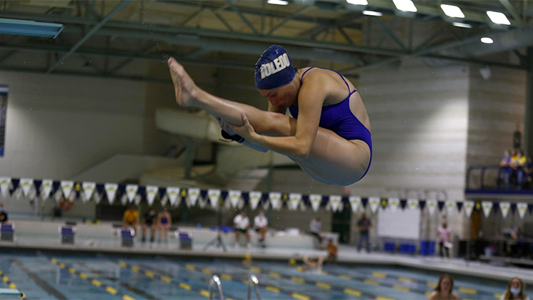 A photo of University of Toledo diver Madison Giglio mid-dive at a competition. She was recently named a Second-Team Academic All-American by the College Swimming and Diving Coaches Association of America.
