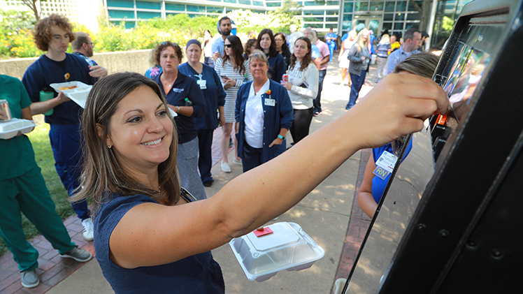 Kelly Donovan, fiscal manager for UTMC, plays “Prize Drop,” a Plinko-type game from “The Price is Right,” during Thursday’s 2023 Employee Appreciation Summerfest.