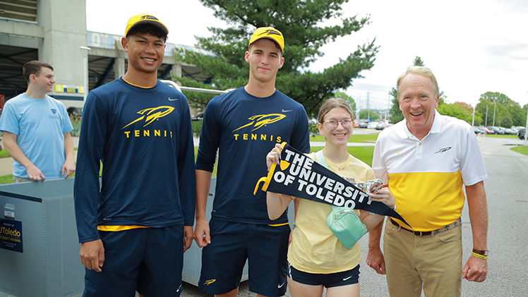 University of Toledo President Gregory Postel joined students and their families to help unpack vehicles during move-in day on Thursday, including freshman Kaitlyn Sullivan with help from men’s tennis players, from left, Poonthong Komolpisutis and Charlie Snow.