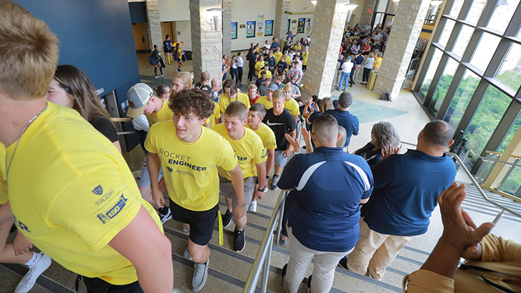 UToledo freshman walk the stairs at Savage Arena at the beginning of 2022 fall semester as UToledo staff and faculty clap during the annual new student convocation.