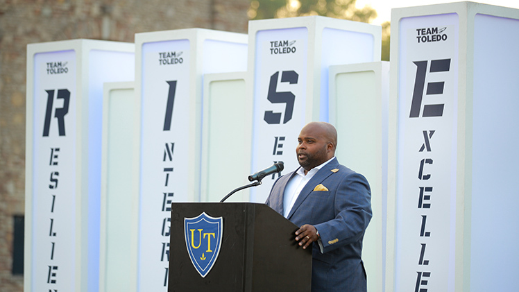 Vice President and Director of Athletics Bryan B. Blair at a podium to announce Toledo Athletics' Rise Together is a five-year strategic plan that outlines a roadmap for student-athlete well-being and success, community engagement and facility enhancements that aims to elevate the Rockets into national prominence.