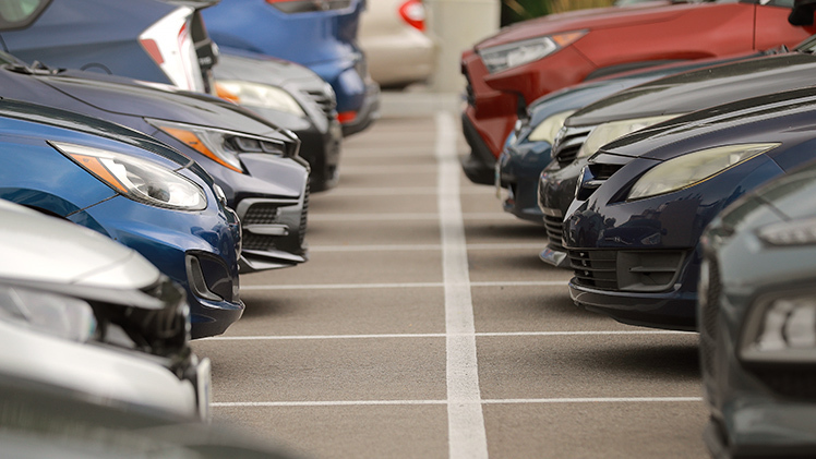 A file photo of the hoods of cars facing each other in a UToledo parking lot.