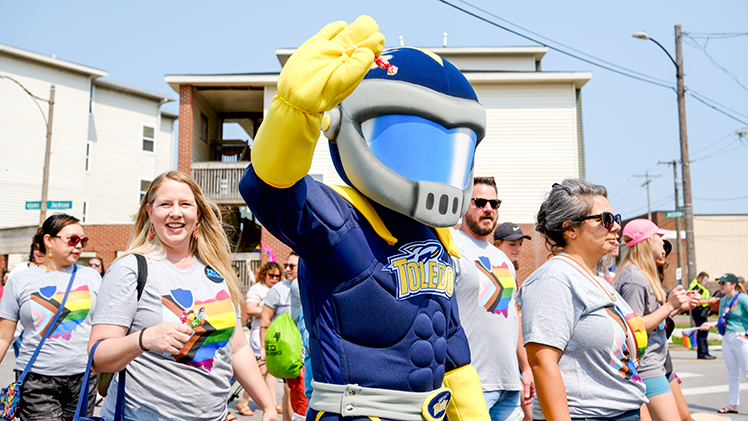 Rocky waves as he marches with the the UToledo contingent in the Toledo Pride Parade on Saturday. 