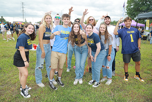 UToledo students pose for a photo at the new tailgating location closer to Glass Bowl Stadium.