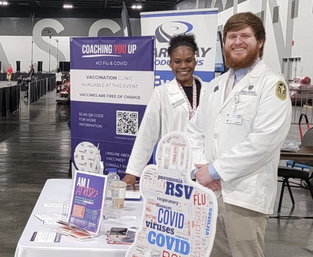 Photo of Sydney Dunnom and Noah Brown, both third-year doctor of pharmacy students in The University of Toledo College of Pharmacy and Pharmaceutical Sciences, as volunteers at a USA Boxing vaccine awareness event this summer.