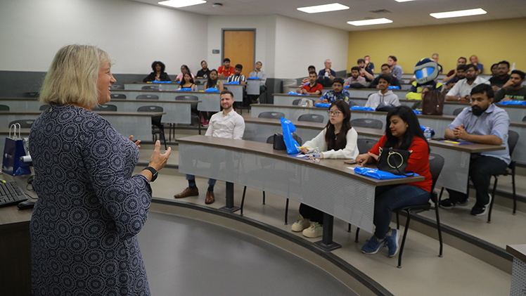 Dr. Anne L. Balazs, dean of the Neff College of Business and Innovation, talks to the new class of international students in the College of Business as part of a welcome event.