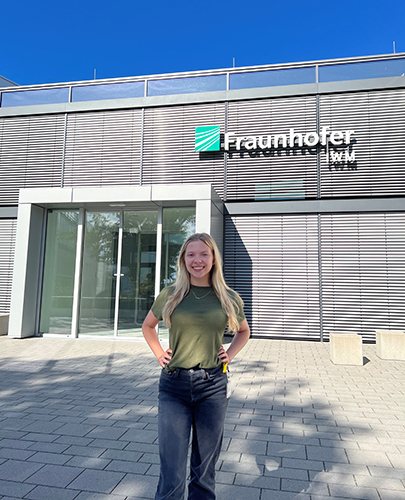 A photo of Lia Sanford, a junior in mechanical engineering at UToledo, in front of the Fraunhofer Institute for Mechanics and Materials building in Freiburg, Germany where she spent the summer as a materials science engineering intern.