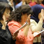 A photo of people in the process of becoming U.S. citizens during a naturalization ceremony in 2022 at The University of Toledo College of Law’s McQuade Auditorium.