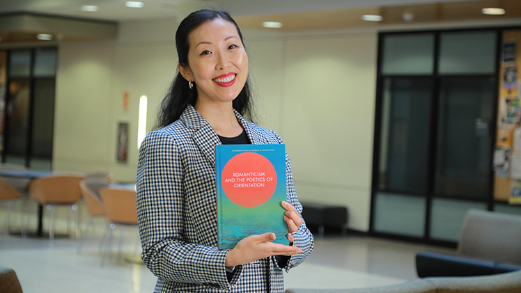 Dr. Joey S. Kim, an assistant professor in the Department of English Language and Literature, holds her latest published book, “Romanticism and the Poetics of Orientation.”