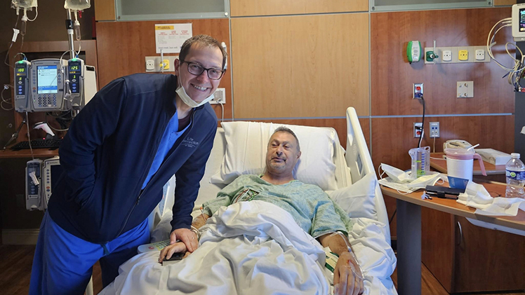 UTMC surgeon Dr. John Rabets poses with Issam Andoni in a UTMC hospital room after performing his successful kidney transplant.