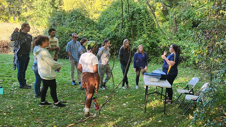 Megan Ginther, a lab technician in Dr. Trisha Spanbauer’s lab at the UToledo Lake Erie Center, instructs members of the Society of Environmental Advocates on how to sample water for ERIeDNA at Stranahan Arboretum.