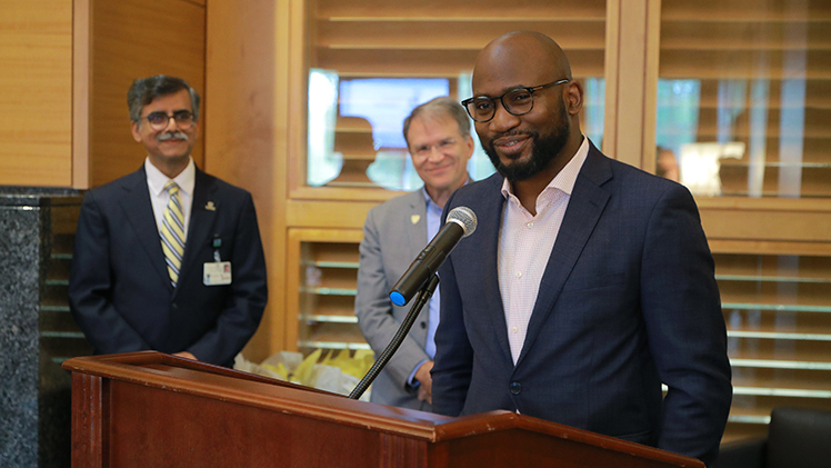 Dr. Obi Ekwenna, a transplant and urologic surgeon at UTMC, speaks during the Oct. 19 ceremony at the Center for Alumni and Donor Engagement as Dr. Puneet Sindhwani, left, chair of the UTMC Department of Urology, and Dr. Michael Rees, a transplant surgeon and surgical director of UTMC’s kidney transplant program, look on.