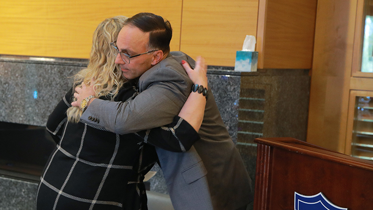 Sherry Baker shares an embrace with Dr. Michael Ellis, chief medical officer at UTMC, after speaking about her need for a transplant and experience at the hospital.