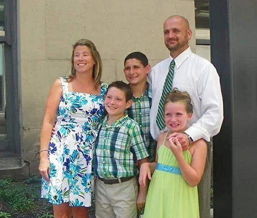 Family photo of Adrian Woliver and his two younger siblings, Chad and Melanie, and their adopted parents, Angel and her husband, Chad, in 2011.