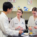 Dr. Gabriella Baki, center, an associate professor of pharmaceutics, works in her lab with undergraduate cosmetic science and formulation design students Lin Khant Maung, left, and Lois Lancaster.