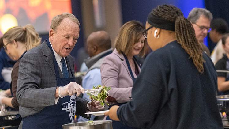 UToledo President Gregory Postel talks with a student as he and other University leaders serve lunch at Monday’s Thanksgiving Wellness Luncheon in Thompson Student Union Auditorium.