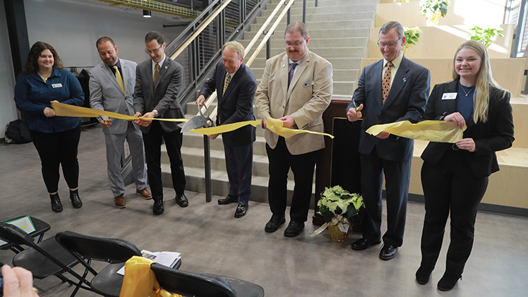 Payton Kamer, a chemical engineering senior; Jason Toth, senior associate vice president for administration; Dr. Scott Molitor, interim provost and executive vice president for academic affairs; Dr. Gregory Postel, president of UToledo; Dr. Brent Cameron, professor and chair of Department of Bioengineering; Dr. Mike Toole, dean of the College of Engineering; and Lisa Kaiser, a bioengineering senior, cut a ceremonial ribbon to open the renovated North Engineering Building on Thursday, Dec. 14.